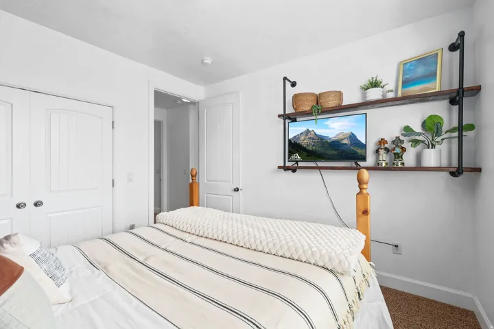 Built-in shelving with dark wood-finish shelves and black metal pipe supports