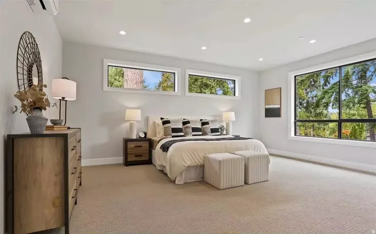 Spacious room featuring broadloom carpeting, recessed lighting, and large windows