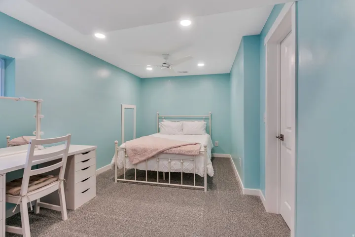 Recessed lighting, light blue walls, gray carpet, white trim, and a white ceiling fan
