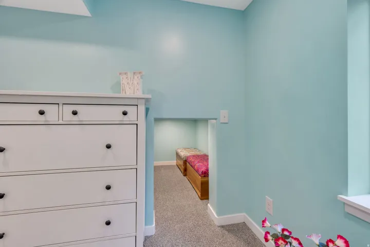 Built-in alcove with recessed lighting, light blue wall paint, white trim, and gray carpet flooring