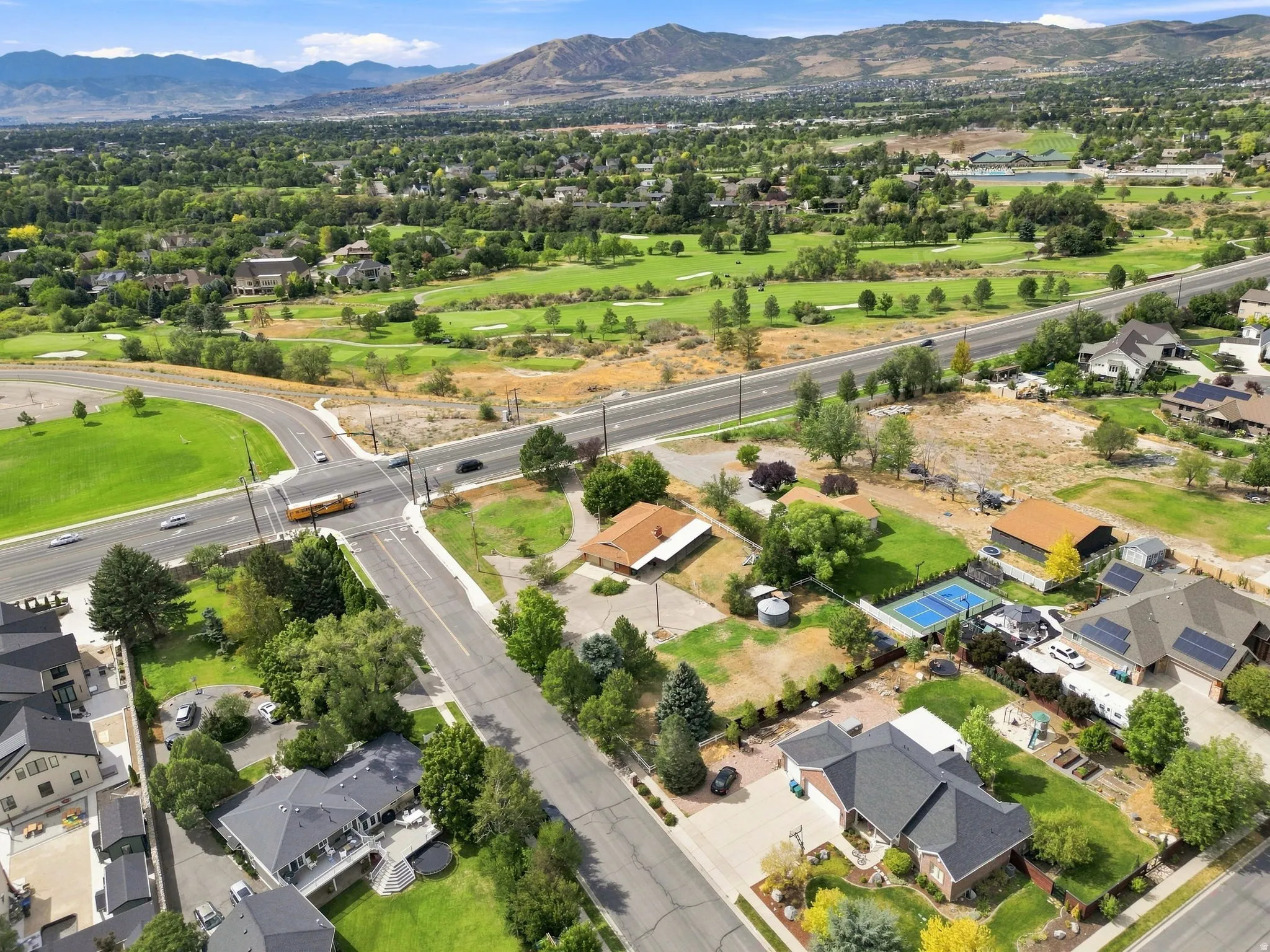 Expansive green spaces and mature trees surrounding residential properties