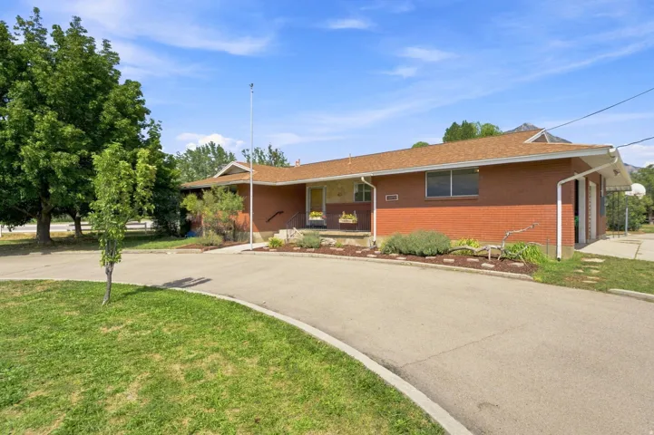 Brick exterior with a brown shingle roof