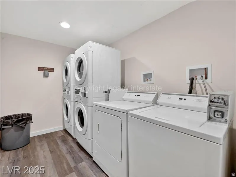 Laundry area featuring wood-finish flooring, recessed lighting, and white walls
