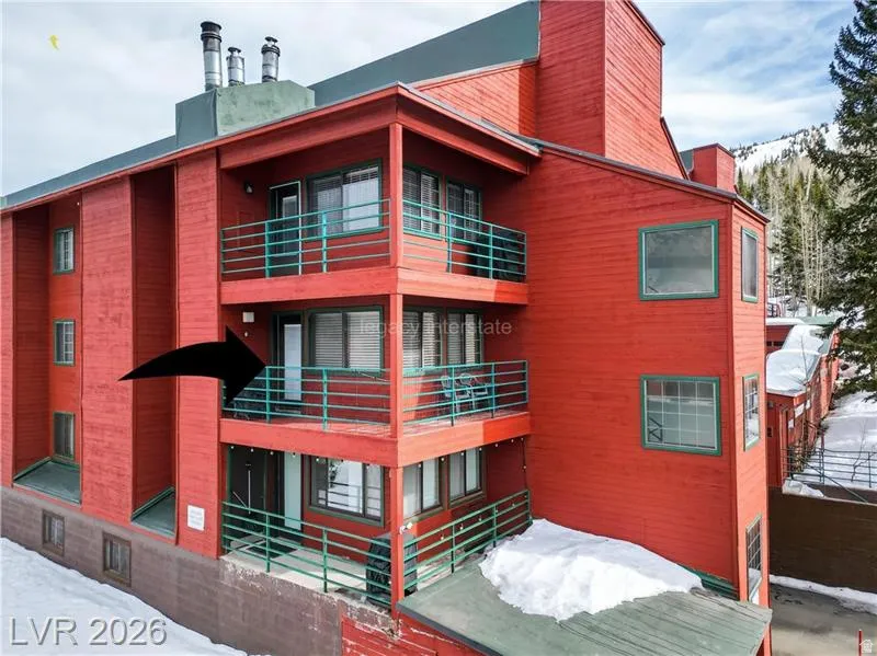 Multi-level building with red exterior siding and green trim accents