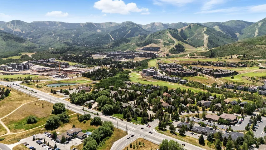 Expansive mountain terrain with visible ski runs, surrounded by residential properties and commercial buildings