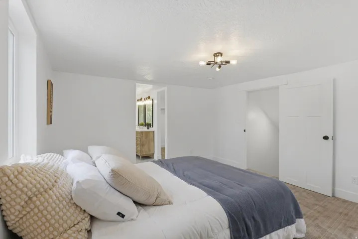Recessed window, modern semi-flush mount light fixture, white interior walls, wood-finish flooring, white barn door