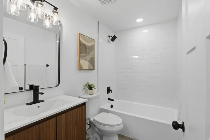 Modern vanity with wood-finish cabinetry and white countertop
