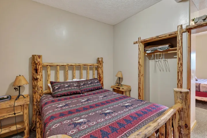 Rustic wood-frame bed with matching nightstands