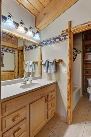 Wood-finish vanity with an integrated sink and light-toned countertop
