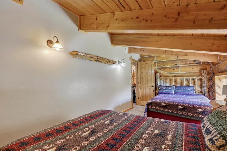 Wood plank ceiling with exposed wood beams