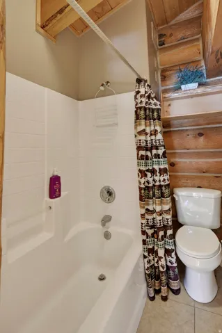 White ceramic tub and shower combination with chrome fixtures