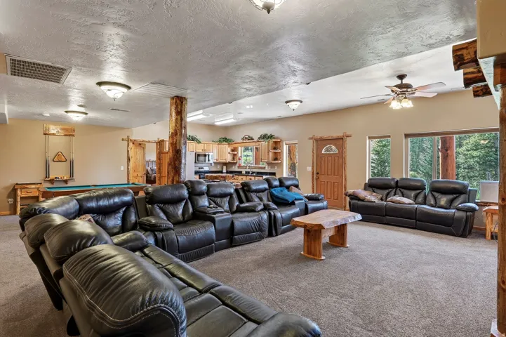 Expansive open-concept room featuring carpeted flooring and recessed lighting