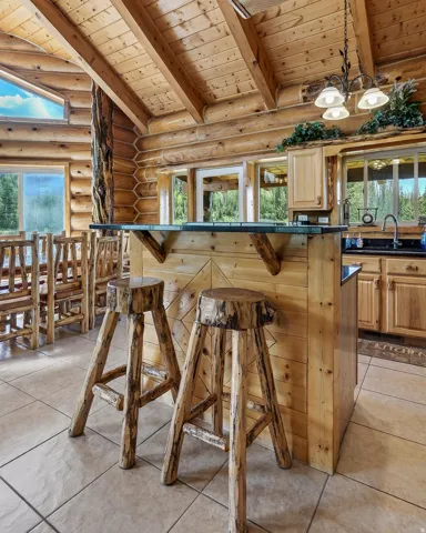 Exposed wood beam ceiling with log construction