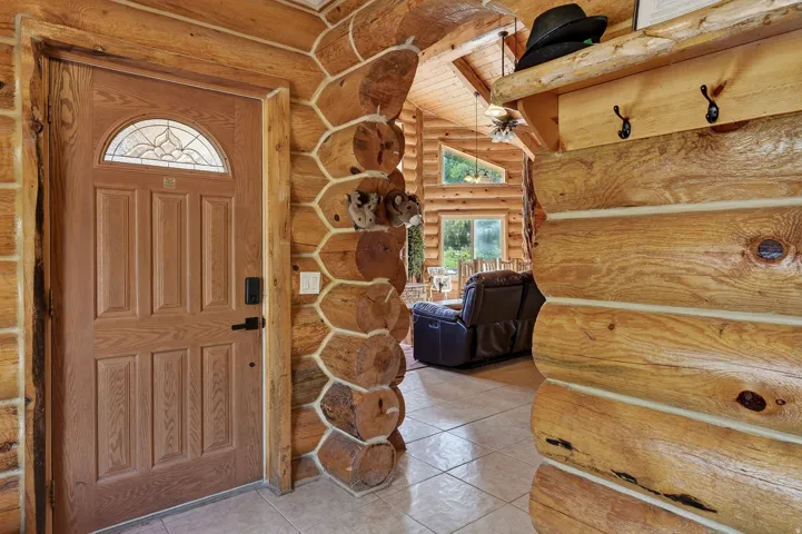 Paneled entry door with an arched decorative glass insert