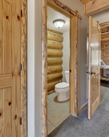 Wood-paneled interior doors, natural wood trim, and log-style wall detailing