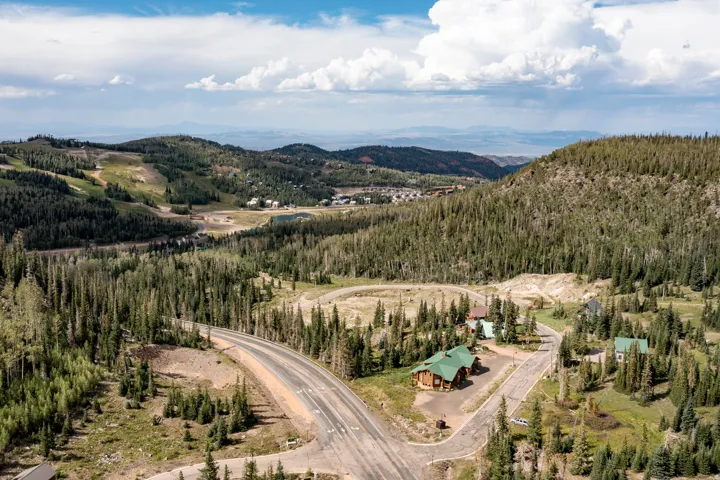 Mountainous terrain with extensive tree coverage and visible roads