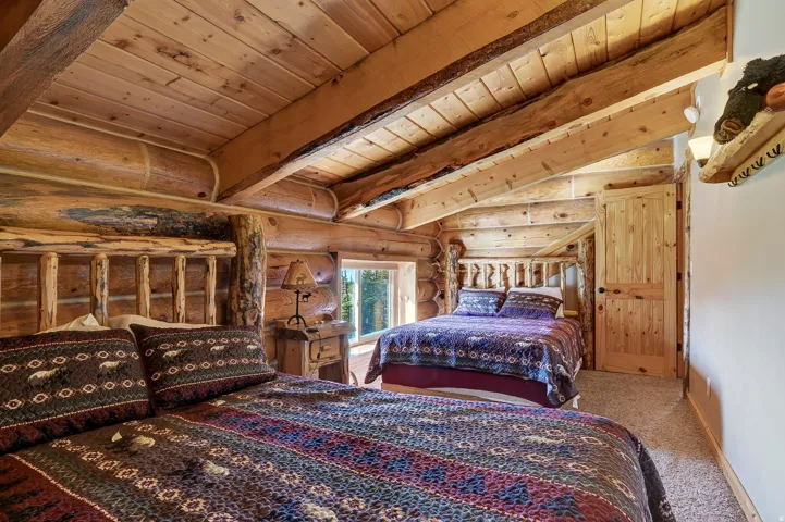 Exposed wood beam ceiling, wood-paneled walls, wood-finish flooring, built-in window, and wood interior door