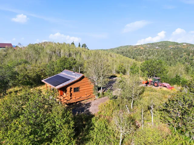 Log cabin exterior with an exposed wood facade and a metal roof