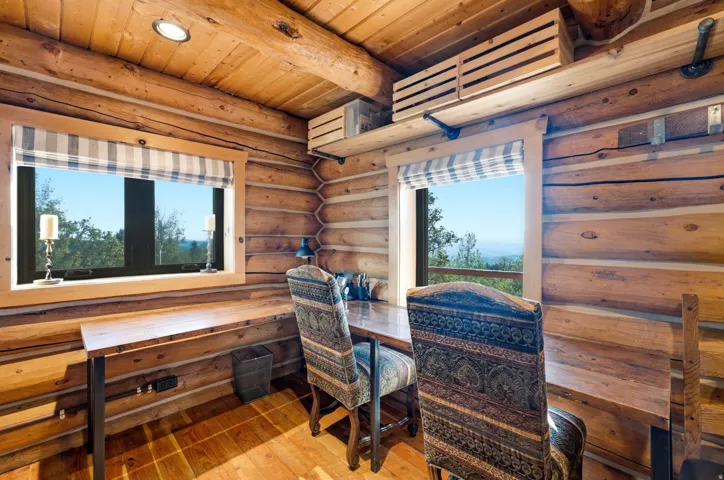 Wood-paneled walls and ceiling with exposed log beams