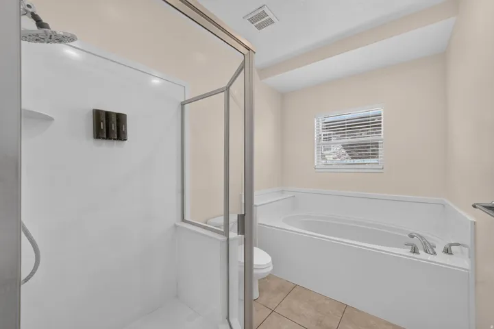 Dedicated shower stall with a fixed showerhead and glass enclosure