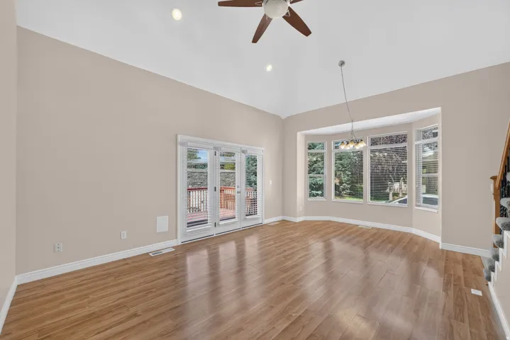 Vaulted ceiling with recessed lighting and ceiling fan