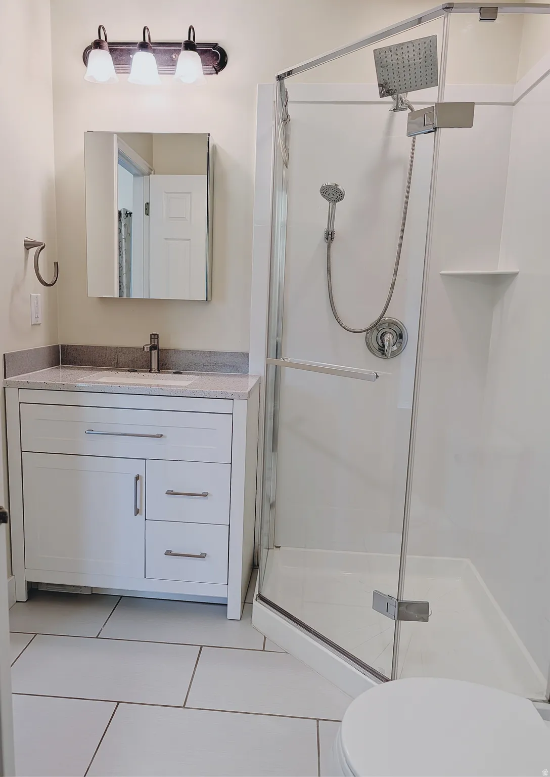 White shaker vanity with a light-colored countertop