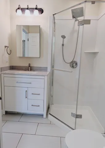 White shaker vanity with a light-colored countertop