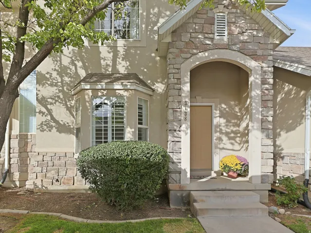 Stucco and stone exterior with an arched entryway