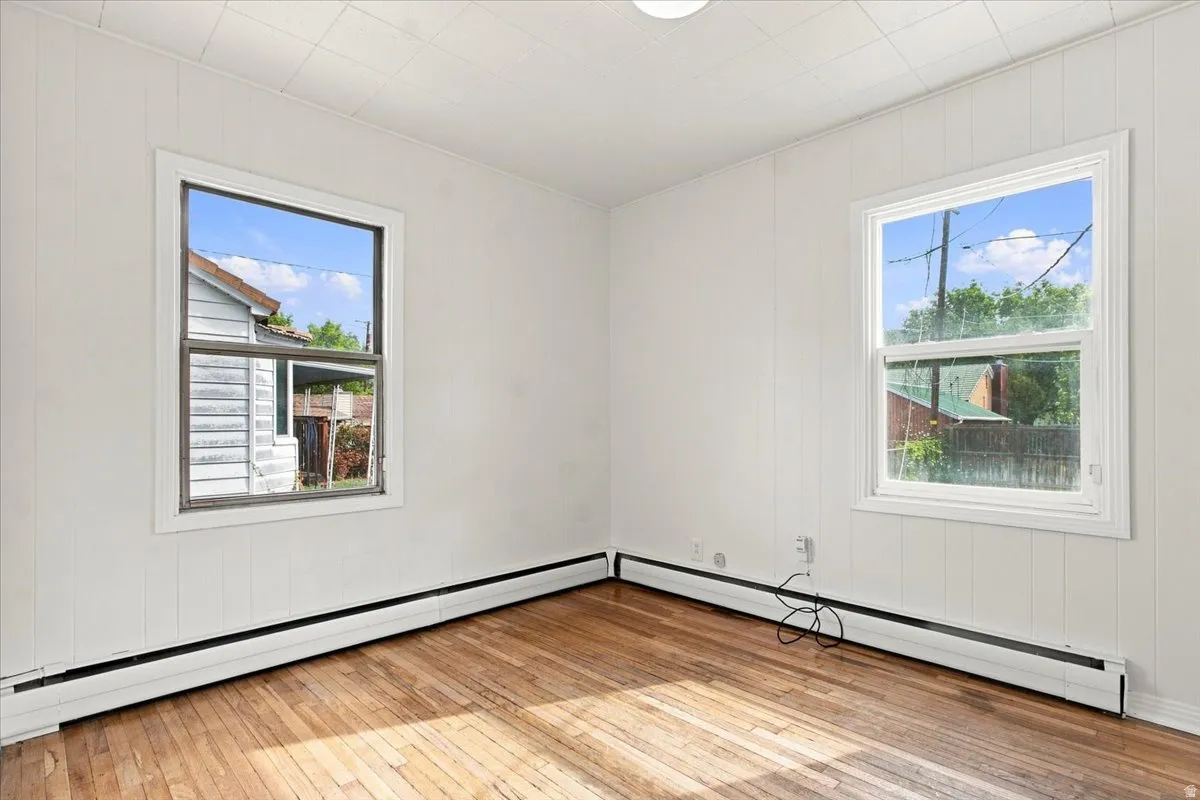 Wood-finish flooring with white wall paneling