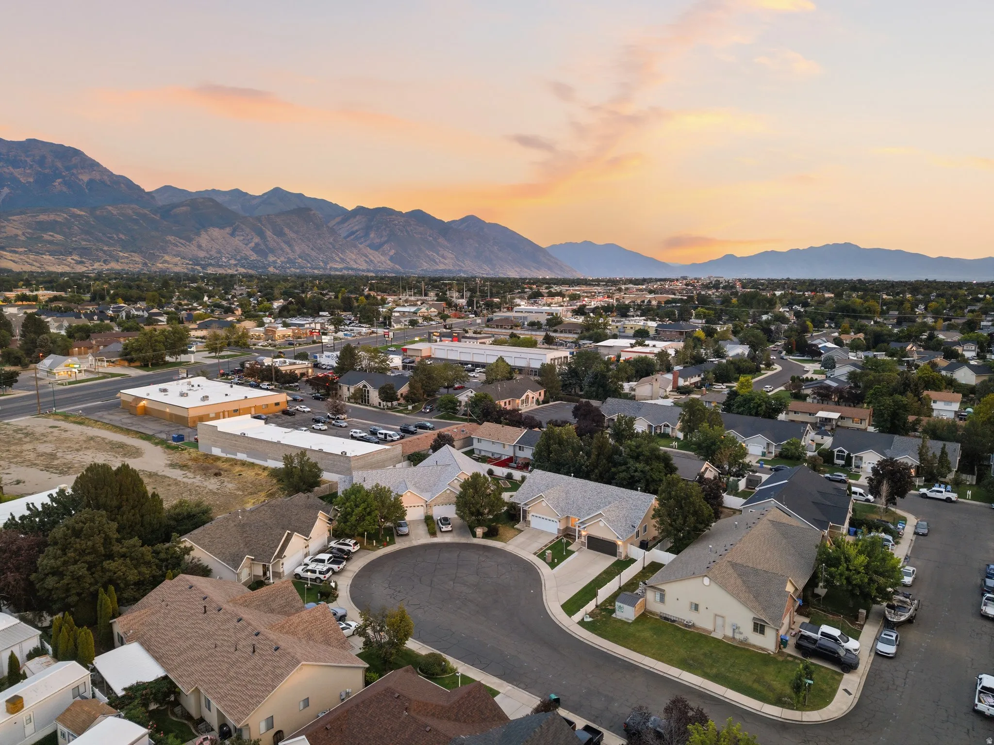 Mountainous backdrop framing a residential community with mature trees