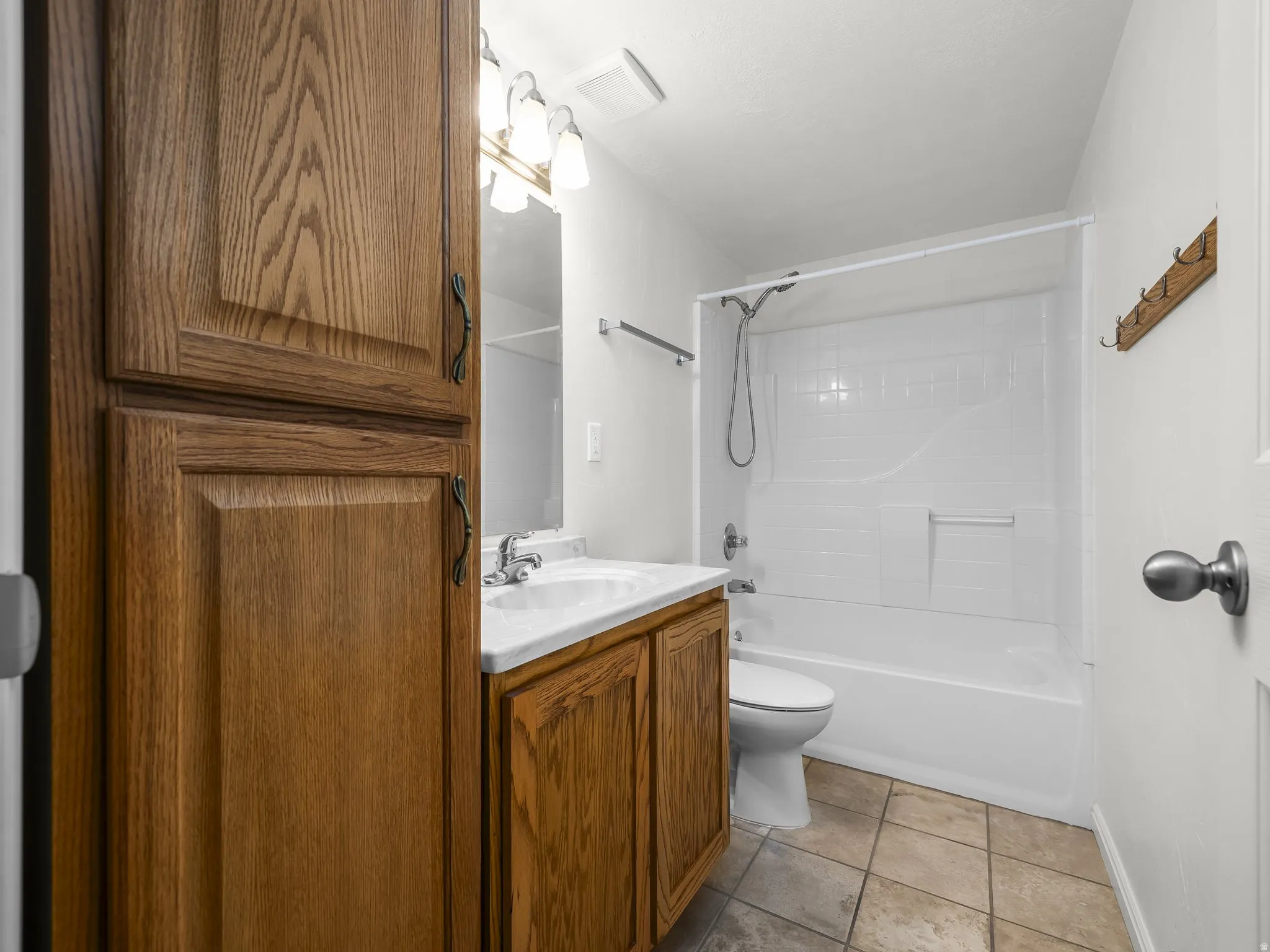 Wood-finish cabinetry providing extensive storage