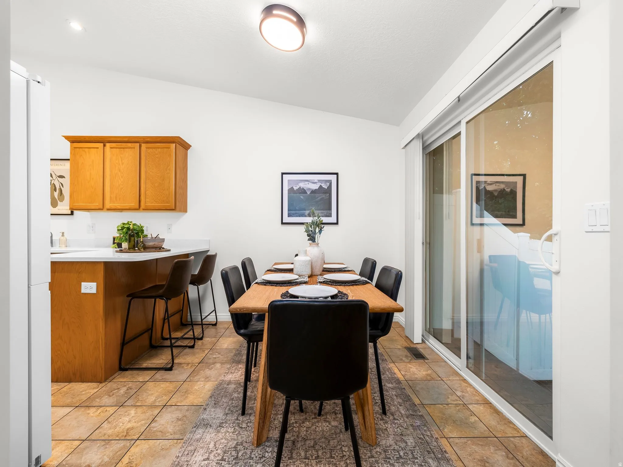 Kitchen, adjacent dining area, and sliding glass door
