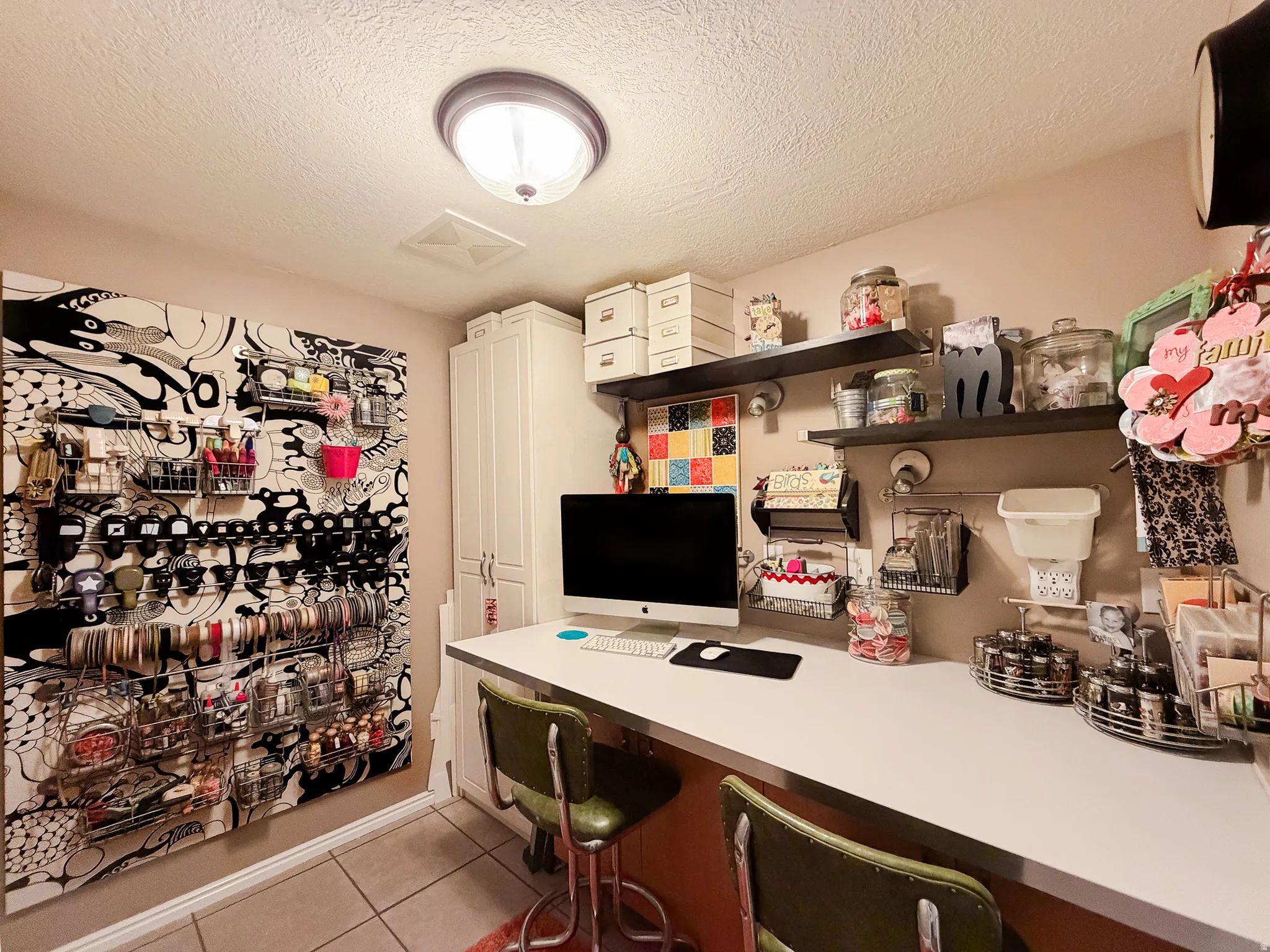Recessed ceiling lighting, built-in white cabinetry, wall-mounted shelving, and a long built-in desk surface
