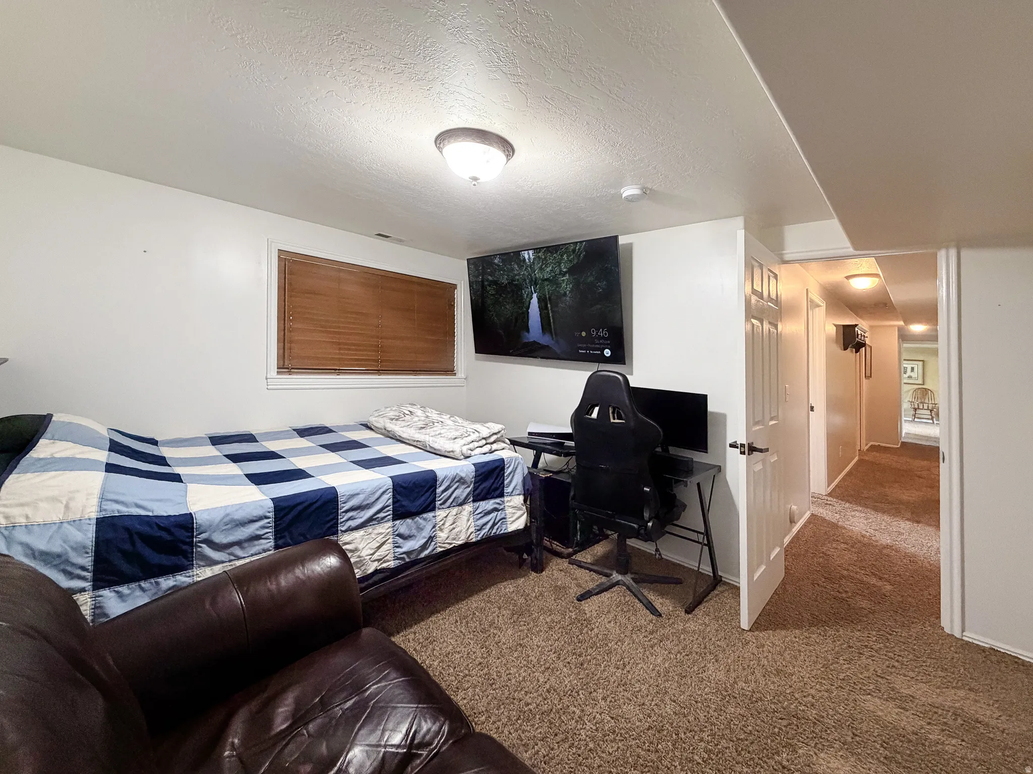 Carpet flooring, recessed window with blinds, interior door, and hallway access