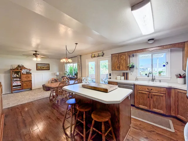 Kitchen featuring wood-finish cabinetry, white countertops, and a stainless steel dishwasher