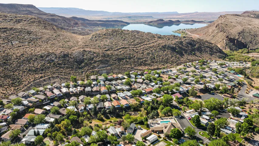 Residential community nestled among arid mountains, featuring a distant body of water