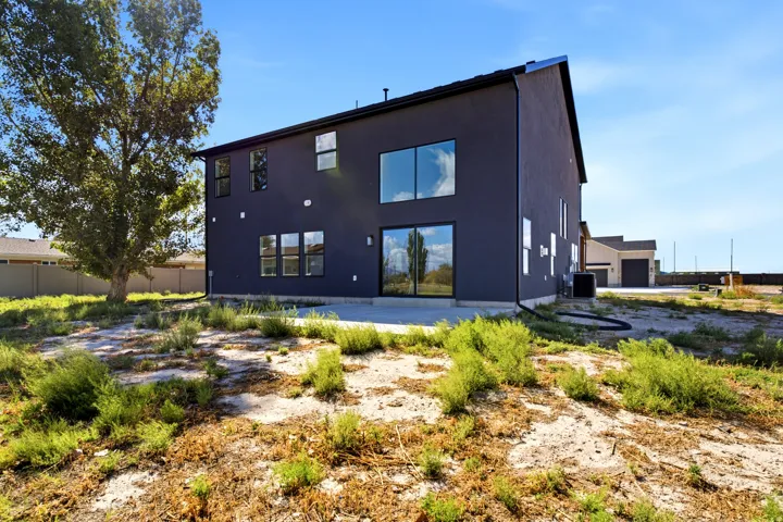 Modern exterior with dark-toned siding and multiple large windows