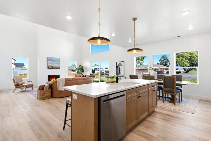 Open-concept interior featuring high ceilings, wood-finish flooring, and ample natural light