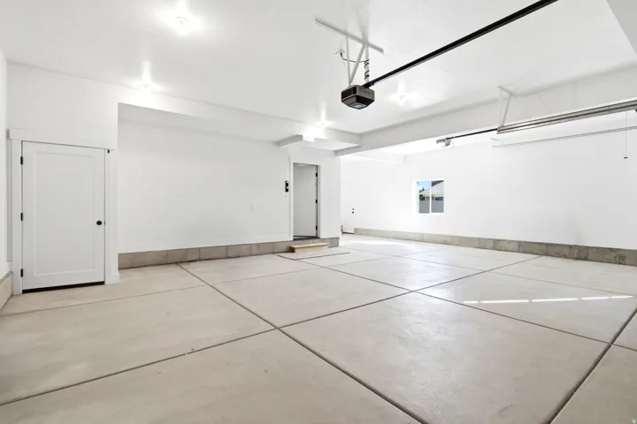 Spacious garage with concrete flooring, recessed lighting, and a single window