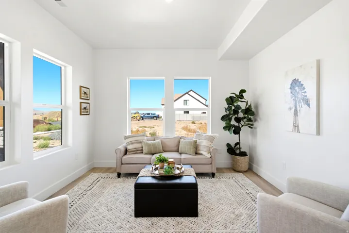 White walls, wood-finish flooring, recessed lighting, and multiple windows