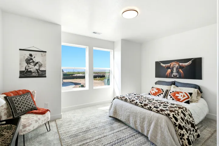 Recessed ceiling lighting, two large windows, white walls, and light-toned carpet flooring