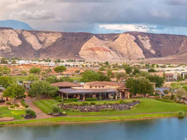 Expansive grounds featuring a manicured lawn, established landscaping, and a water feature