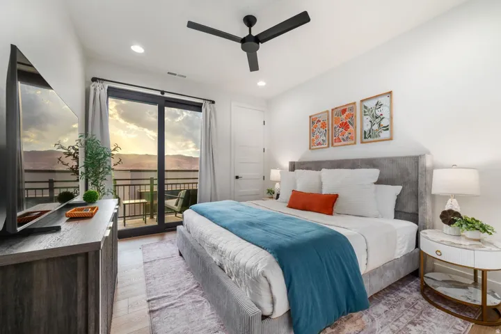 Recessed lighting, ceiling fan, hard-surface flooring, sliding glass door, and private balcony with metal railing