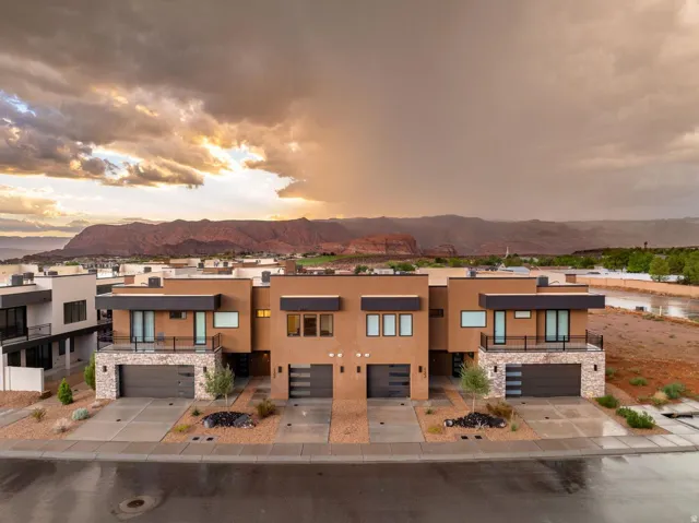 Modern architectural design featuring stucco and stone veneer exteriors