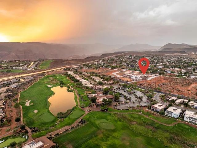 Community featuring a golf course, expansive lake, and desert landscape