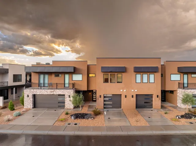 Contemporary stucco exterior with stone accents, featuring a private balcony