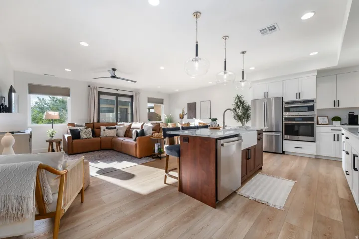 Expansive open-concept living area featuring light wood-finish flooring
