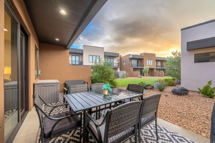 Covered patio with recessed lighting, sliding glass door, and gravel landscaping