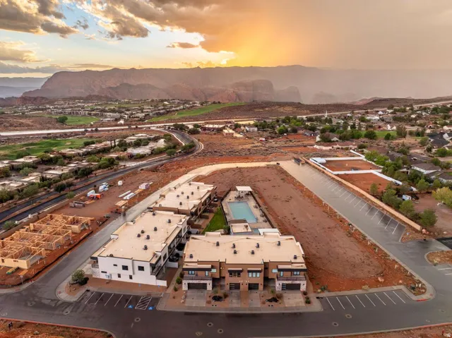Modern townhome community with a communal swimming pool and surrounding mountainous landscape