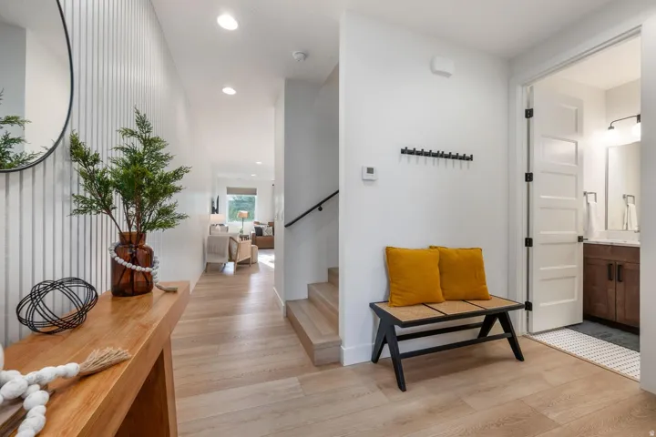 Entryway featuring wood-finish flooring, recessed lighting, and a modern wall treatment